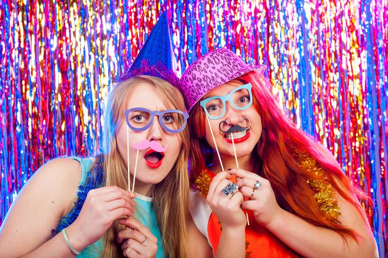 Friends dancing and posing with props at a party